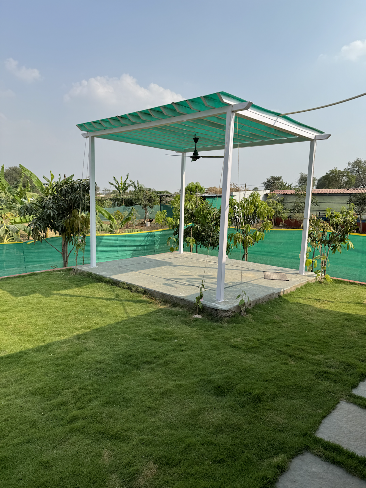 Open pavilion and lawn at The Kutiram