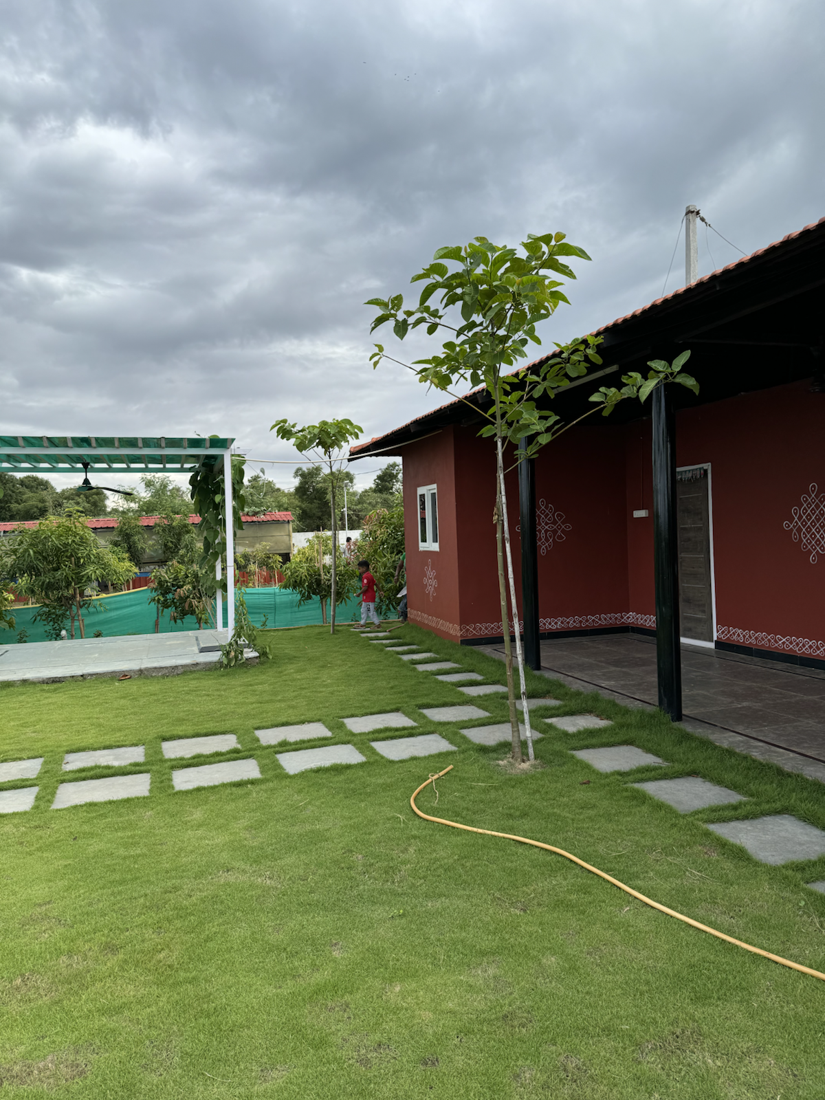Farmhouse lawn and walkway at The Kutiram