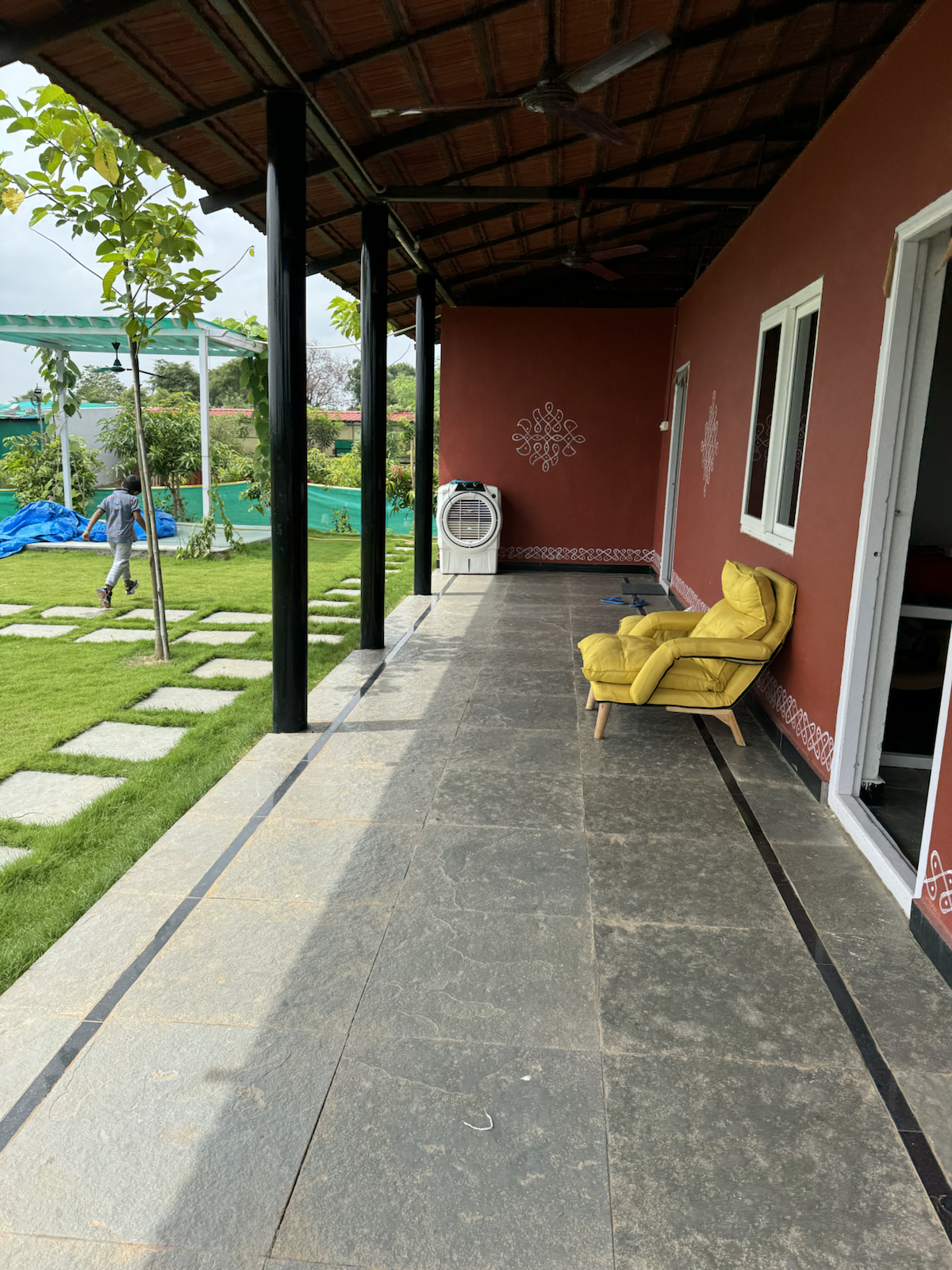 Farmhouse veranda and lawn at The Kutiram
