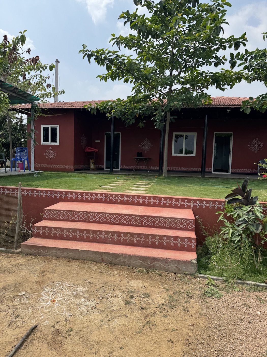 The Kutiram farmhouse frontage under a leafy tree near Hyderabad